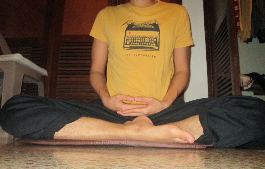 Burmese meditation posture from the front, both shins resting on the floor one in front of the other