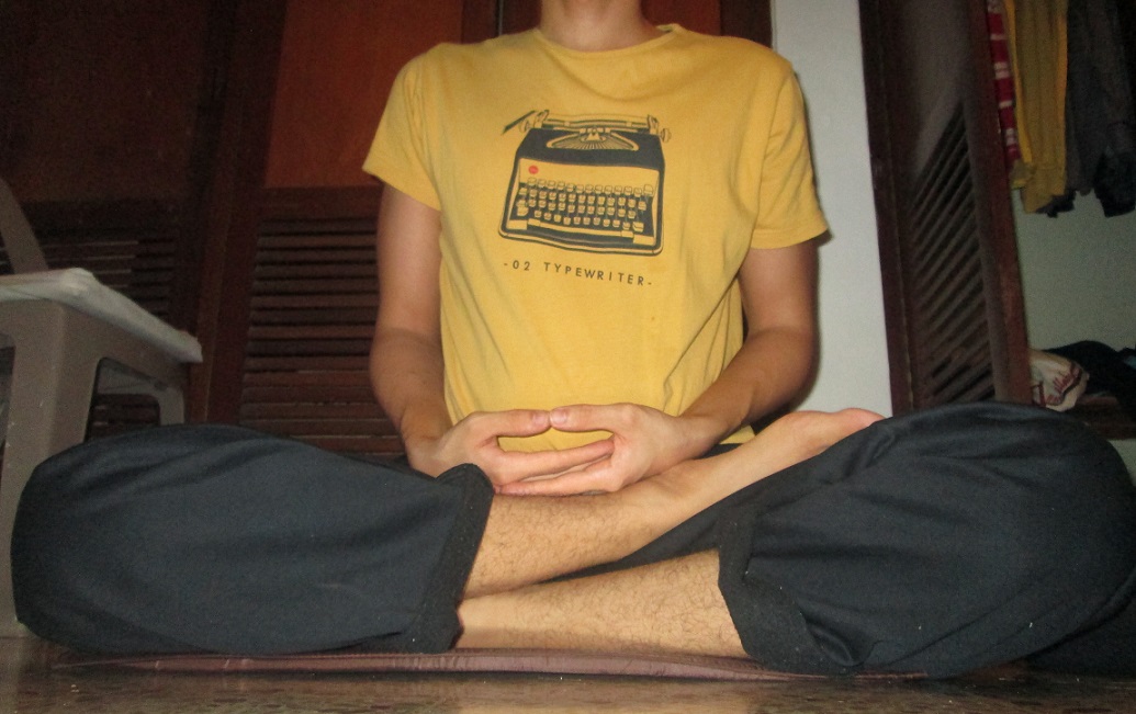 Half lotus posture with one foot drawn up onto the opposite thigh
