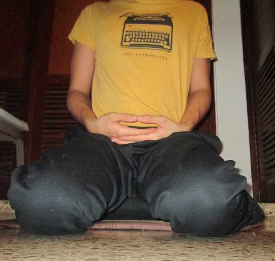 Seiza kneeling meditation posture seen from the front, sitting astride a cushion